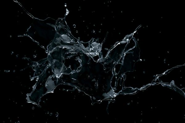 A person in a fluid motion pose against a dark background.