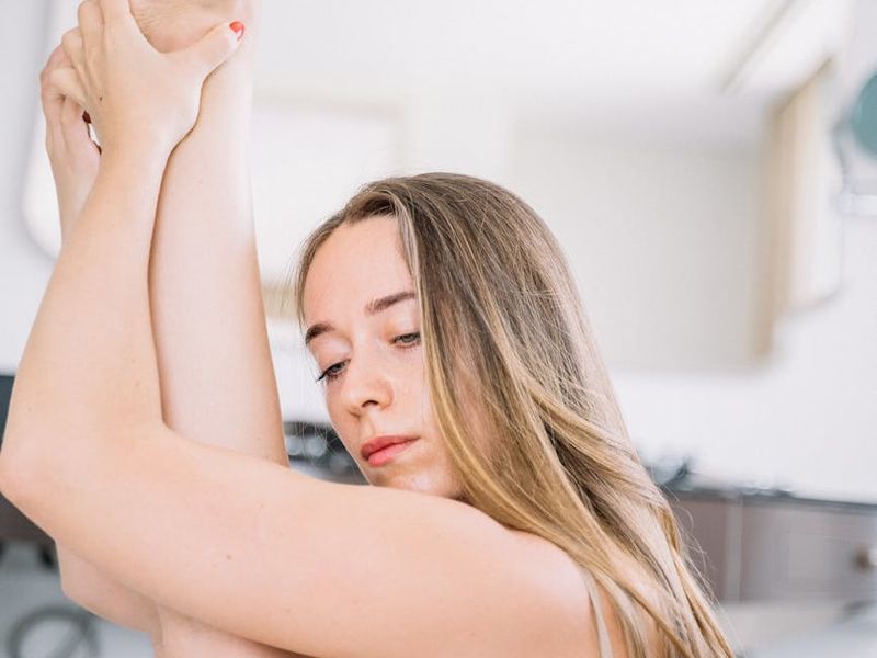 Person in a focused, mindful pose during a workout.